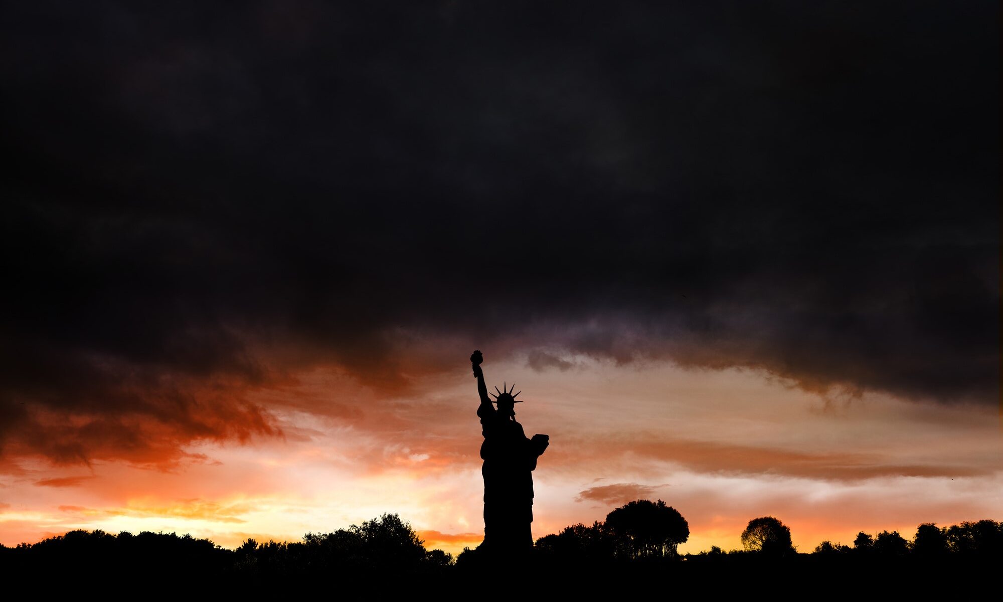 photograph of statue of liberty silhouette